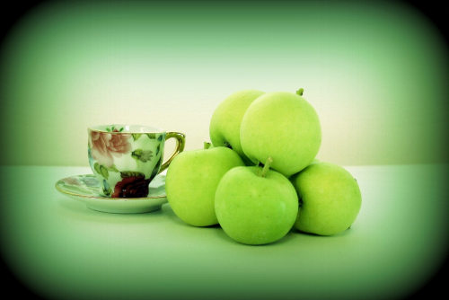 Photo of Granny Smith apples and teacup